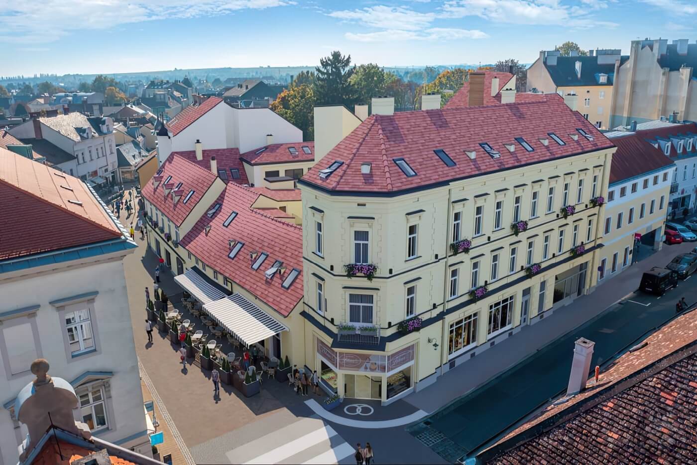 Letecký 3D zákres moderního bytového domu do reálné fotografie stávající městské zástavby a okolní krajiny.