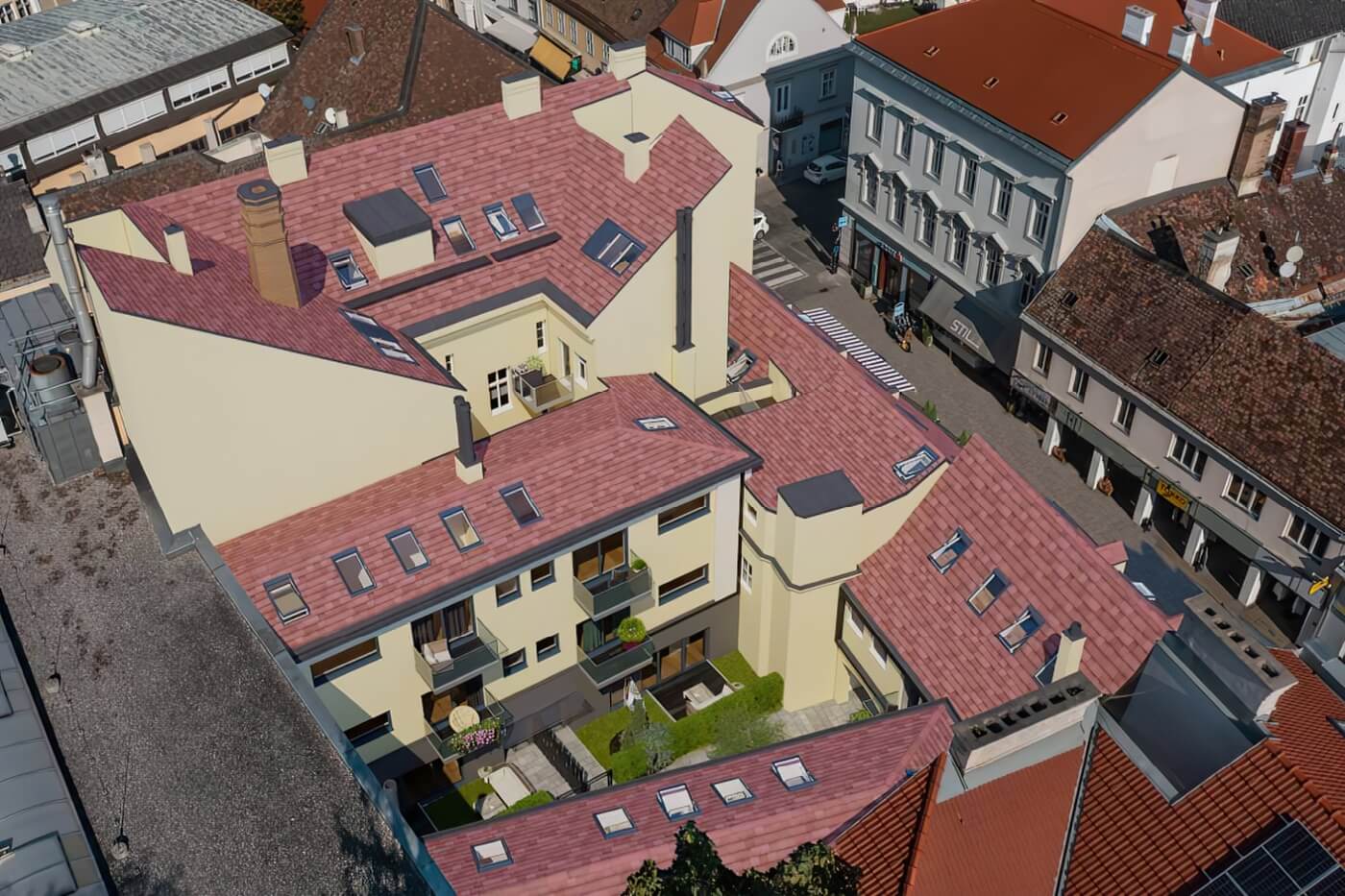 Letecká 3D vizualizace bytového domu s bílou fasádou, dřevěnými balkony, zelenými střechami a členitým vnitroblokem se zahradou.