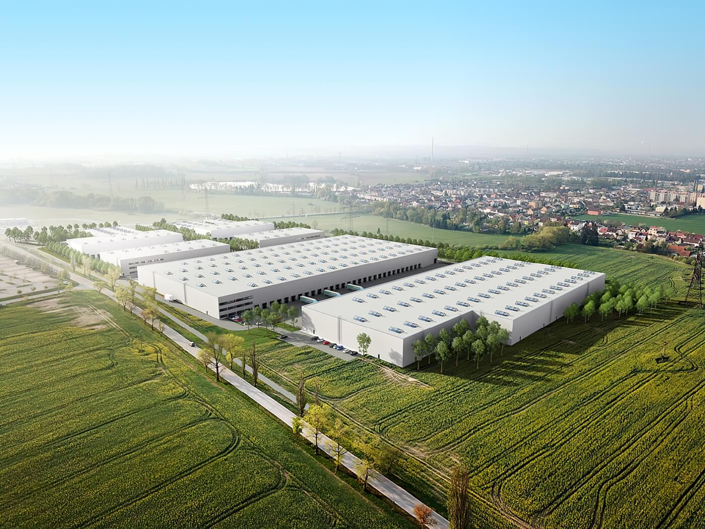 Letecký 3D zákres moderního skladového komplexu do reálné krajiny při západu slunce s detailním nasvícením hal a okolní infrastruktury.